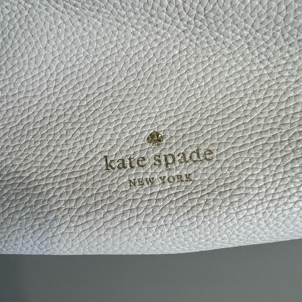 Kate spade purse. White with gold lettering